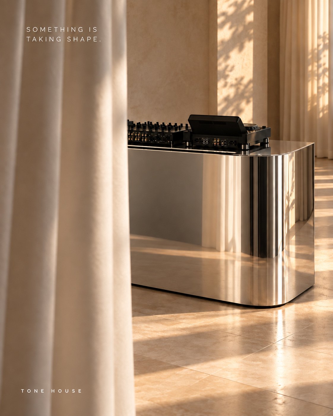 Chrome DJ booth reflecting linen curtains in afternoon light